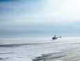 На Байкале дул сильный ветер. По льду бесконечно стелилась поземка, а легкий вертолет, летевший против ветра, приземлялся с большим трудом.