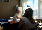 Задержанная за мошенничество женщина и полицейский. Скриншот видео пресс-службы ГУ МВД России по Иркутской области