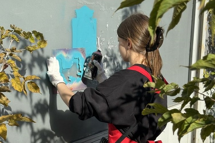 Волонтер закрашивает рекламу. Фото пресс-службы администрации Иркутска