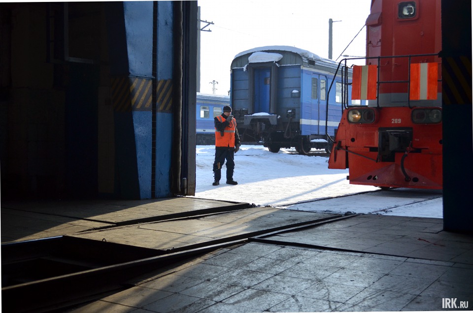 В цех загоняют электровоз-тягач. К нему прицепят электричку и вывезут ее на путь